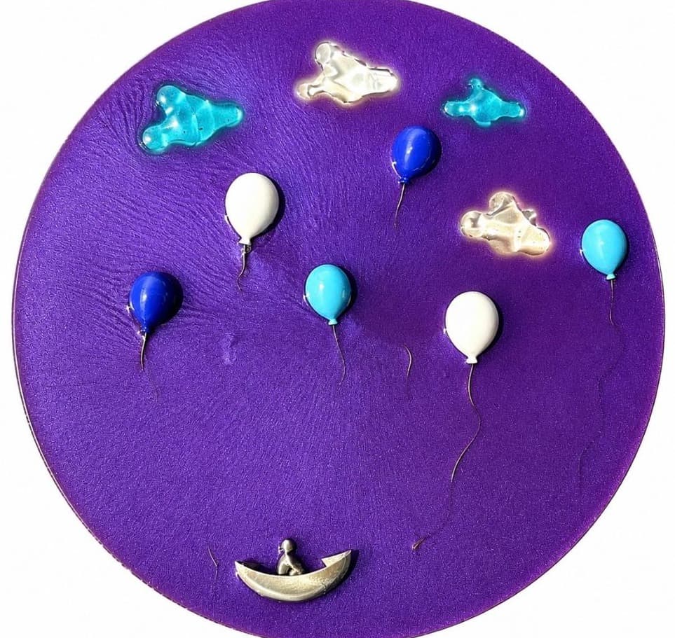 Round purple panel with blue and white balloons, glass clouds and a figure in a silver boat